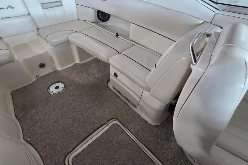 Slide: The Image of Interior of a 2005 Sea Ray 270 SLX boat with beige seating and carpeted floor. - 6