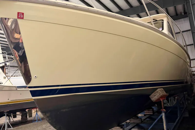 Slide: The Image of 2005 Mainship Pilot 34 boat in storage, showcasing sleek hull design and classic lines. - 1
