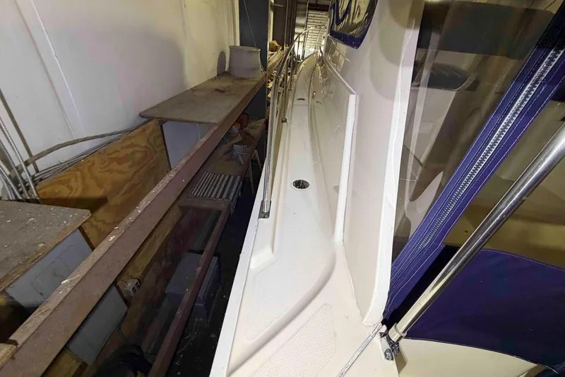 Slide: The Image of 2005 Mainship Pilot 34 boat deck with railing, stored indoors. - 14
