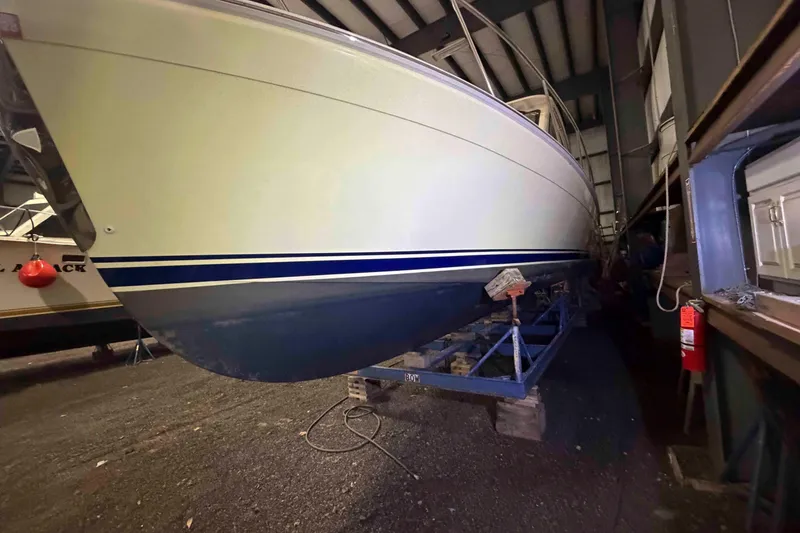 Slide: The Image of 2005 Mainship Pilot 34 boat in storage, viewed from the side, indoors. - 3