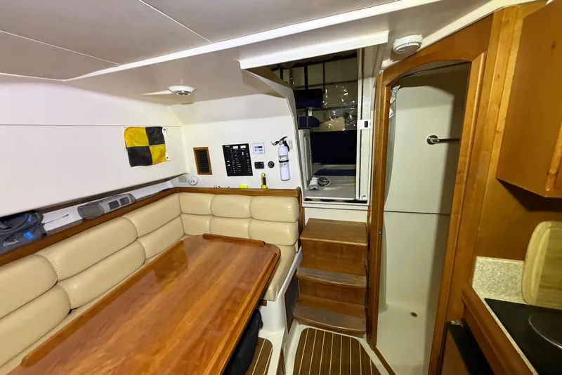 Slide: The Image of Interior of 2005 Mainship Pilot 34 boat with dining area and stairs. - 35