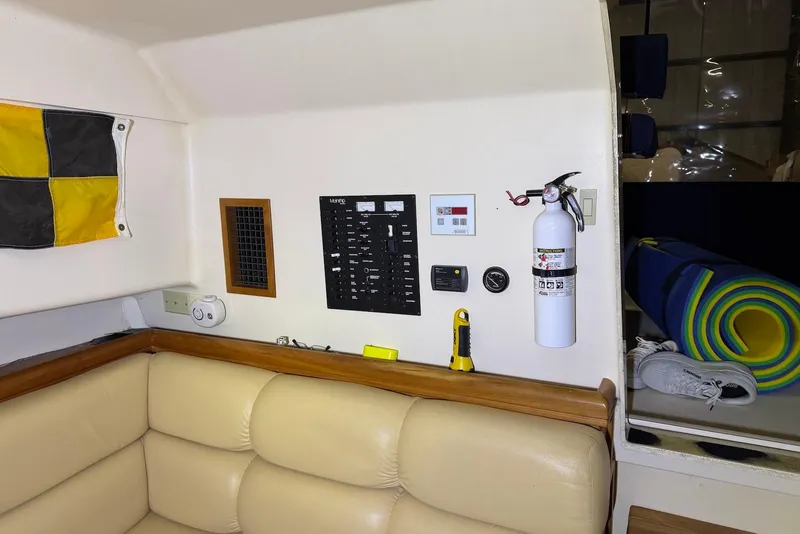 Slide: The Image of Interior of 2005 Mainship Pilot 34 with control panel, fire extinguisher, and seating area. - 37