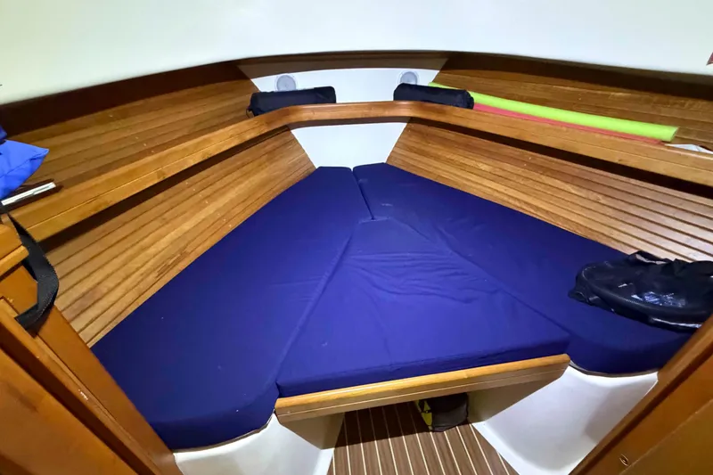 Slide: The Image of Cozy cabin interior of 2005 Mainship Pilot 34 with blue cushions and wooden accents. - 38