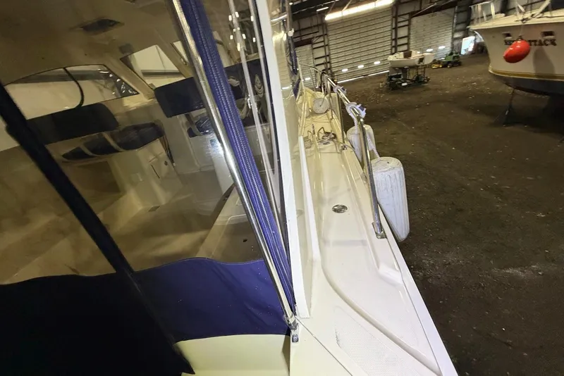 Slide: The Image of 2005 Mainship Pilot 34 boat in storage, showing deck and interior seating. - 4