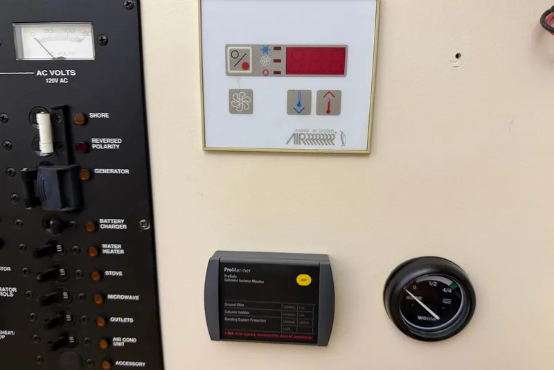 Slide: The Image of Control panel of a 2005 Mainship Pilot 34 boat with various gauges and switches. - 41