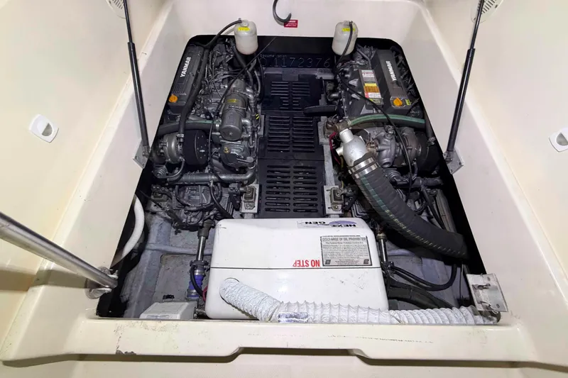 Slide: The Image of Engine compartment of a 2005 Mainship Pilot 34, featuring dual Yanmar engines. - 43