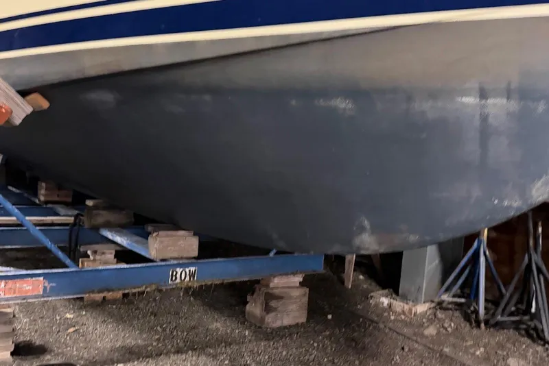 Slide: The Image of 2005 Mainship Pilot 34 boat hull on a support frame in storage. - 44