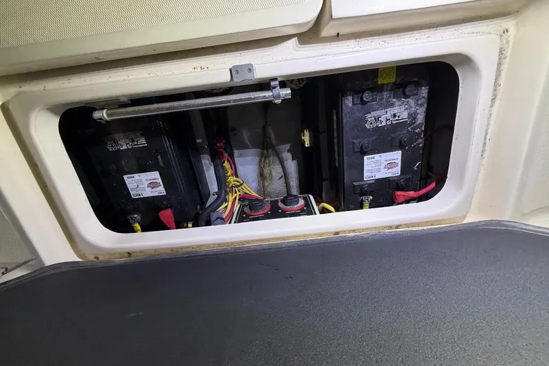 Slide: The Image of Battery compartment of a 2005 Mainship Pilot 34 boat, showing wiring and connections. - 48