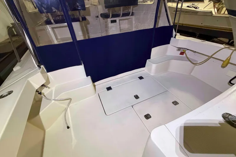 Slide: The Image of 2005 Mainship Pilot 34 boat cockpit with seating and storage compartments. - 5