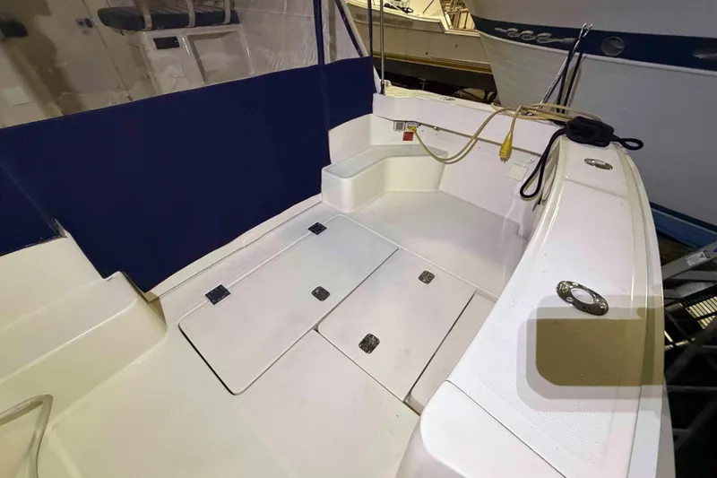 Slide: The Image of 2005 Mainship Pilot 34 boat deck with storage compartments and seating area. - 6
