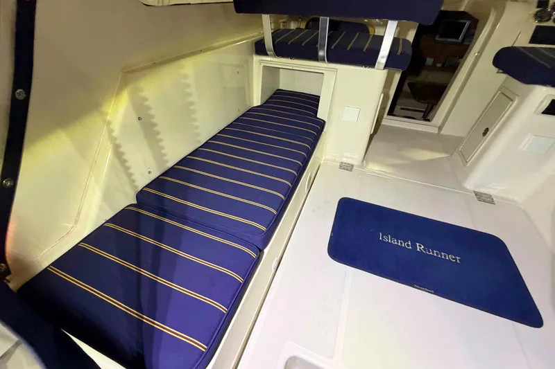 Slide: The Image of Interior of 2005 Mainship Pilot 34 with striped seating and "Island Runner" mat. - 7