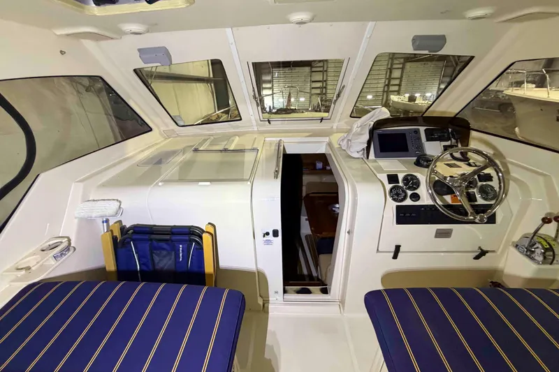 Slide: The Image of 2005 Mainship Pilot 34 boat interior with helm, seating, and navigation equipment. - 8