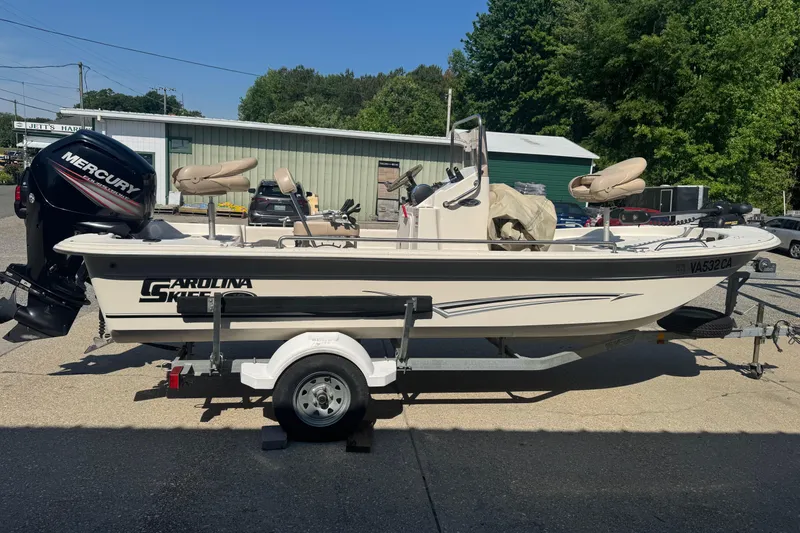 The Image of 2016 Carolina Skiff 18 JVX CC boat on trailer with Mercury engine, parked outdoors. - 0