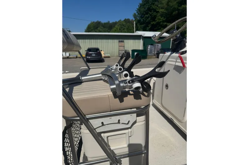 Slide: The Image of 2016 Carolina Skiff 18 JVX CC boat interior with fishing rod holders and steering wheel. - 11