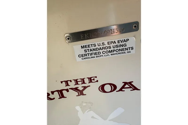 Slide: The Image of 2016 Carolina Skiff 18 JVX CC boat with EPA compliance label and partial name visible. - 15