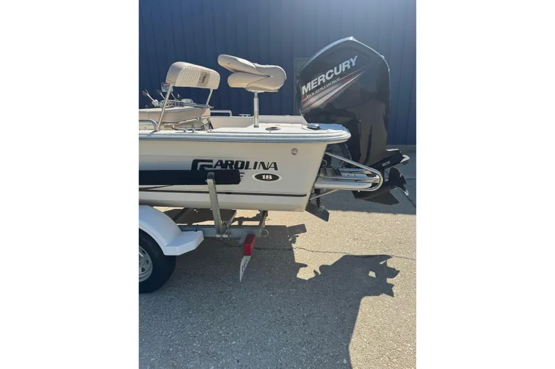 Slide: The Image of 2016 Carolina Skiff 18 JVX CC boat with Mercury engine on trailer. - 2