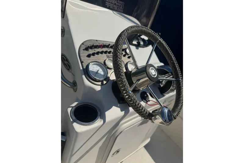 Slide: The Image of Steering console of 2016 Carolina Skiff 18 JVX CC boat with gauges and controls. - 9