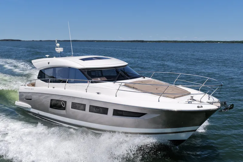 The Image of 2015 Prestige 500S yacht cruising on open water under clear blue skies. - 0