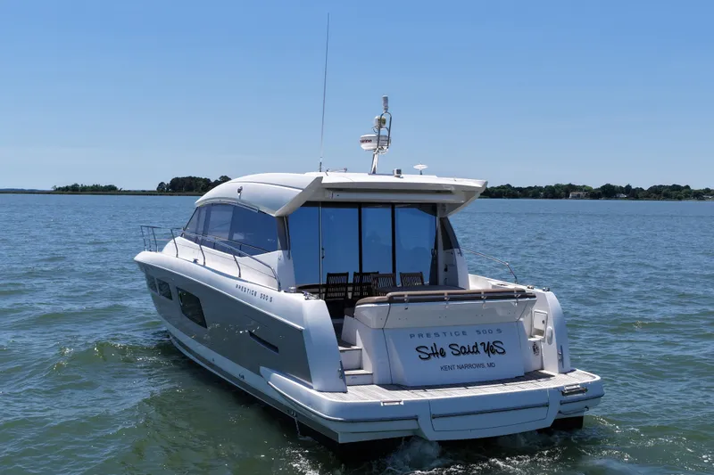 Slide: The Image of 2015 Prestige 500S yacht cruising on open water under clear blue skies. - 12