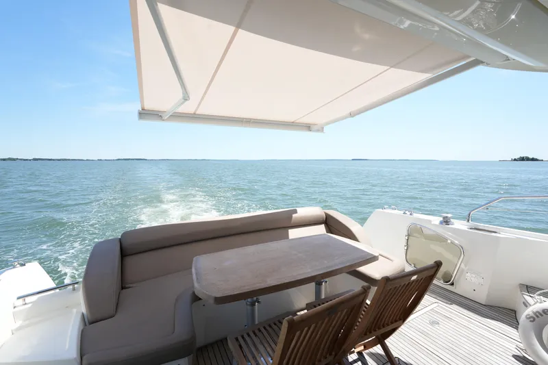 Slide: The Image of Luxury 2015 Prestige 500S yacht deck with seating, table, and ocean view. - 17