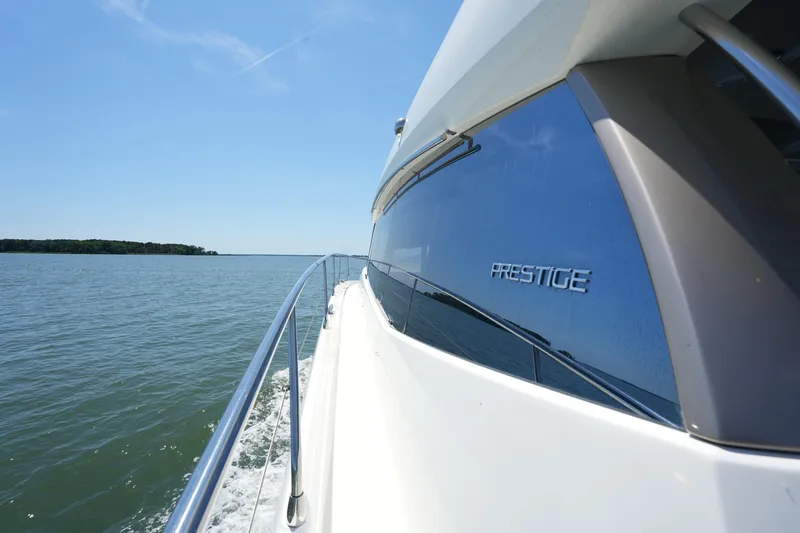 Slide: The Image of 2015 Prestige 500S yacht cruising on open water under clear blue sky. - 19