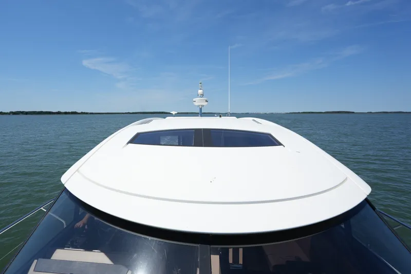 Slide: The Image of 2015 Prestige 500S yacht cruising on calm waters under a clear blue sky. - 24