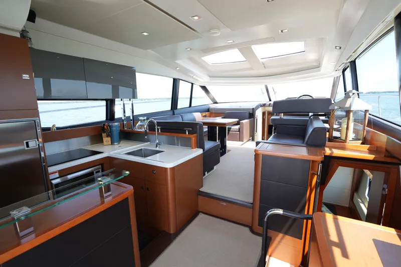 Slide: The Image of Luxurious interior of a 2015 Prestige 500S yacht with modern kitchen and seating area. - 25