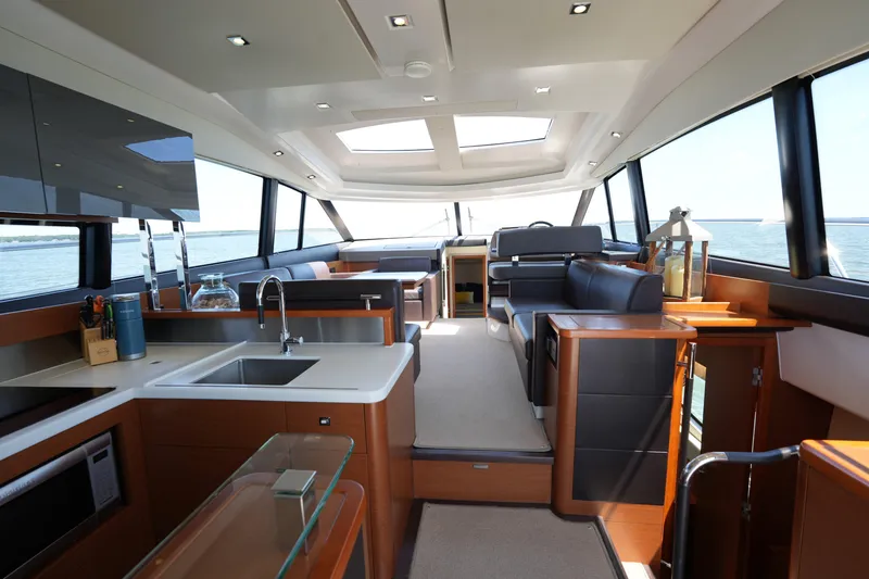 Slide: The Image of Luxurious interior of a 2015 Prestige 500S yacht with modern kitchen and seating area. - 26
