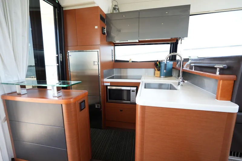 Slide: The Image of Modern kitchen interior on a 2015 Prestige 500S yacht, featuring sleek cabinetry and stainless steel appliances. - 29
