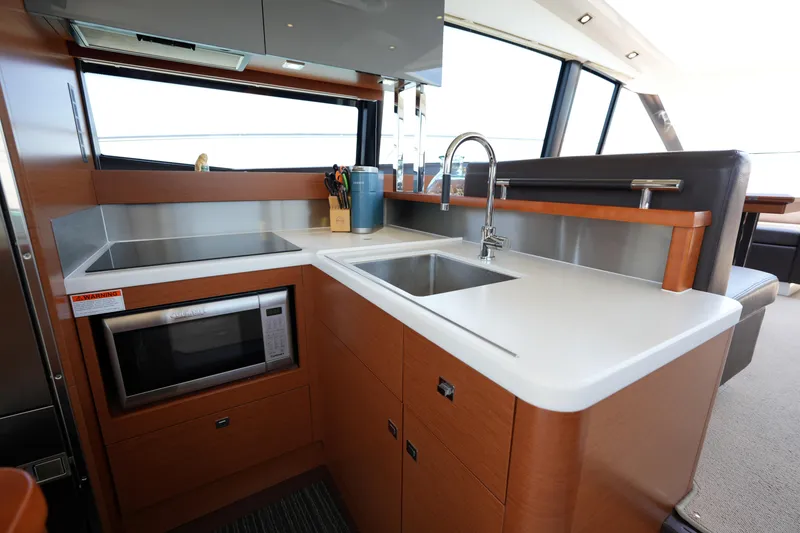 Slide: The Image of Modern kitchen area in a 2015 Prestige 500S yacht, featuring sleek countertops and appliances. - 30