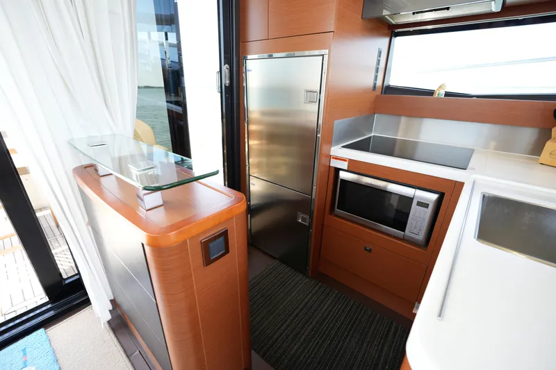 Slide: The Image of Modern kitchen interior on a 2015 Prestige 500S yacht, featuring sleek appliances and wood finishes. - 31