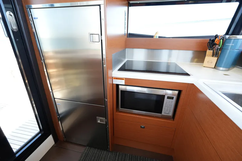Slide: The Image of Modern kitchen in 2015 Prestige 500S yacht with stainless steel appliances and sleek wood cabinetry. - 32