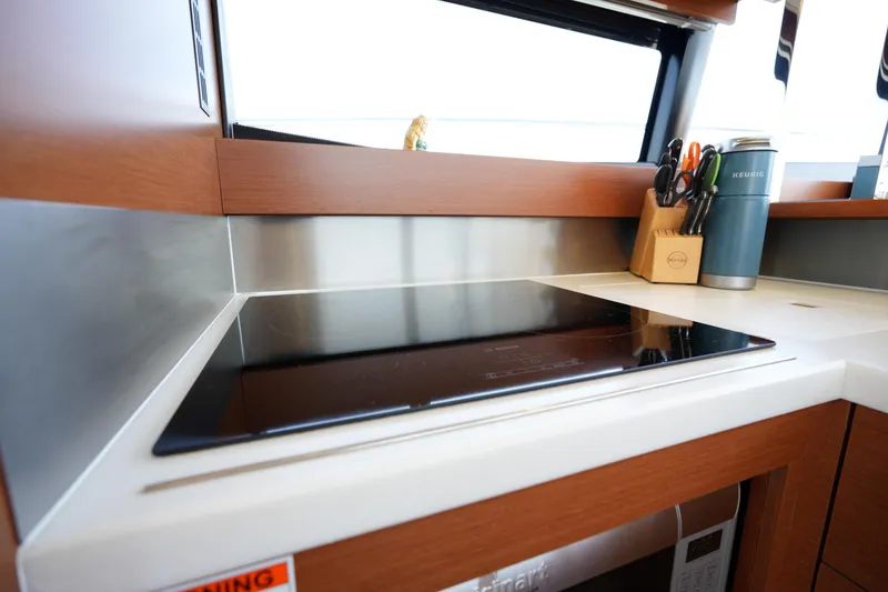 Slide: The Image of Modern kitchen area in a 2015 Prestige 500S yacht with induction cooktop and accessories. - 34
