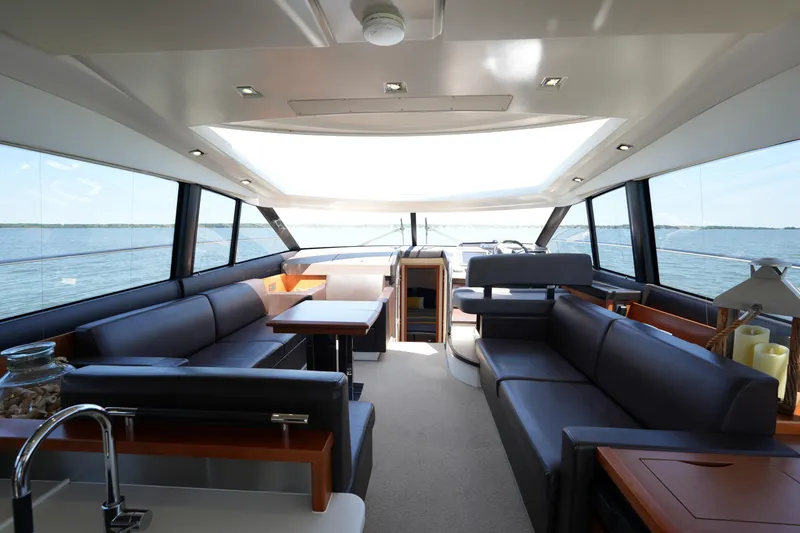 Slide: The Image of Luxurious interior of a 2015 Prestige 500S yacht with panoramic windows and elegant seating. - 36