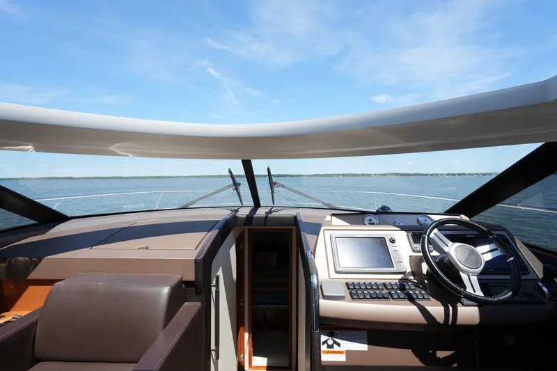 Slide: The Image of Cockpit view of 2015 Prestige 500S yacht on open water under clear blue sky. - 42