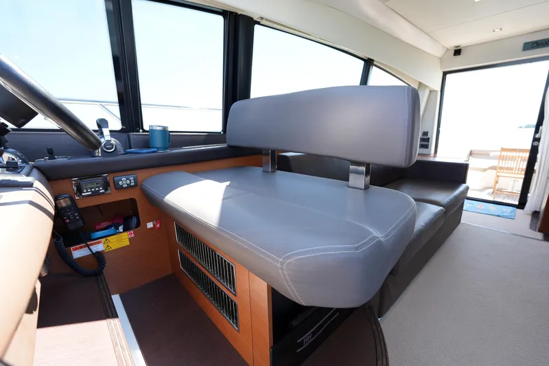Slide: The Image of Interior of a 2015 Prestige 500S yacht, featuring a modern helm seat and control panel. - 45