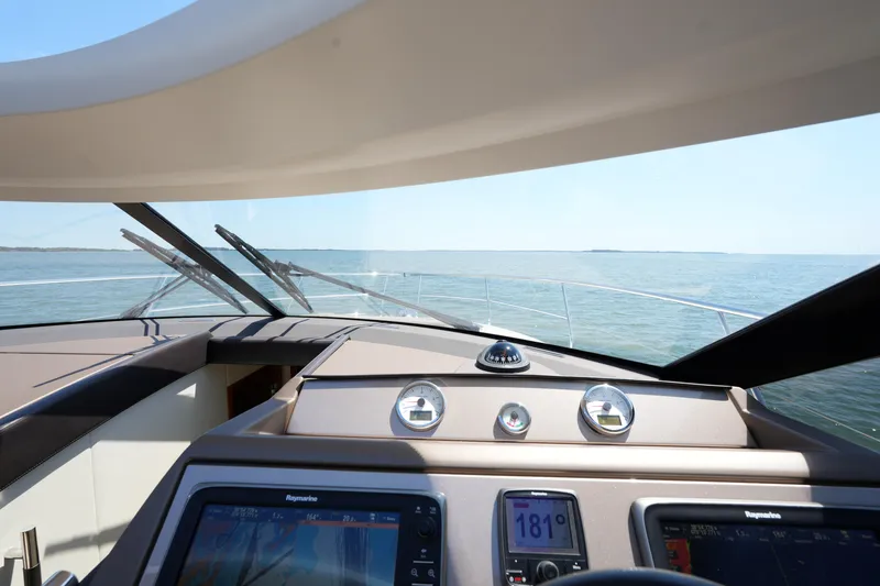 Slide: The Image of Cockpit view of 2015 Prestige 500S yacht navigating open waters. - 48