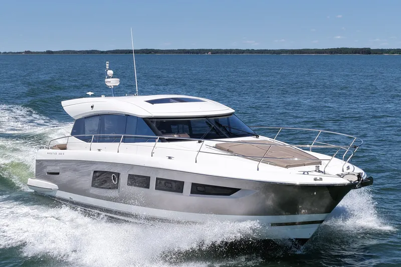 Slide: The Image of 2015 Prestige 500S yacht cruising on open water under clear skies. - 5