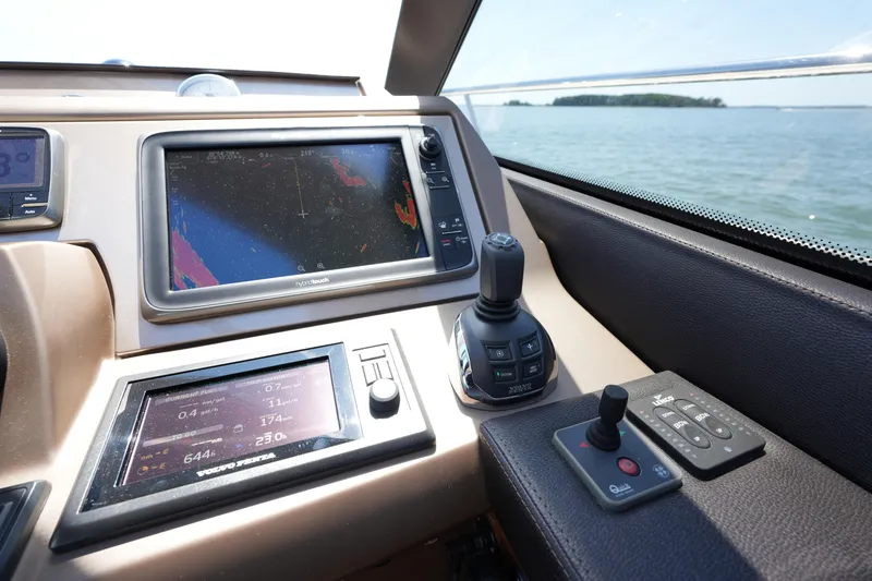 Slide: The Image of Control panel of a 2015 Prestige 500S yacht with navigation screens and joystick. - 51