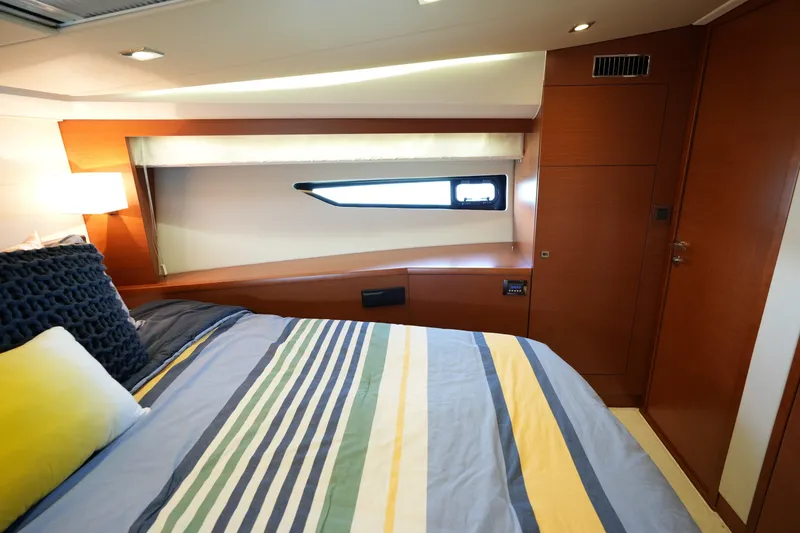 Slide: The Image of Luxurious cabin interior of a 2015 Prestige 500S yacht with striped bedding. - 56