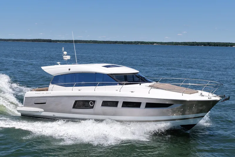 Slide: The Image of 2015 Prestige 500S yacht cruising on open water under clear blue skies. - 6