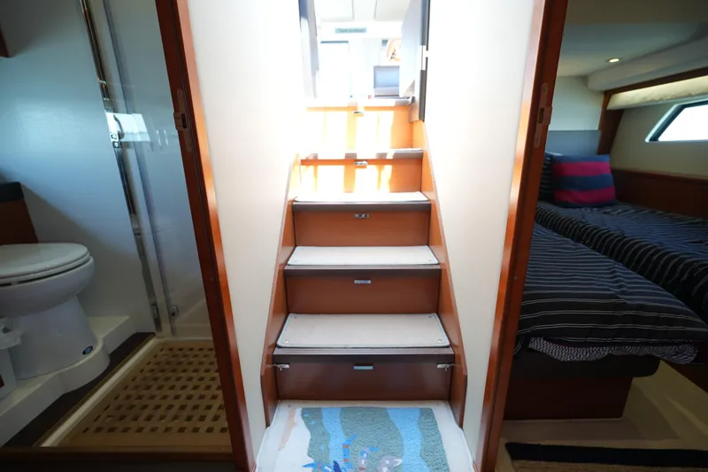 Slide: The Image of Interior of a 2015 Prestige 500S yacht featuring stairs, bathroom, and bedroom. - 63