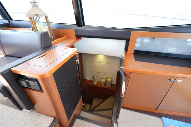 Slide: The Image of Interior of 2015 Prestige 500S yacht, featuring elegant wood cabinetry and a staircase. - 65