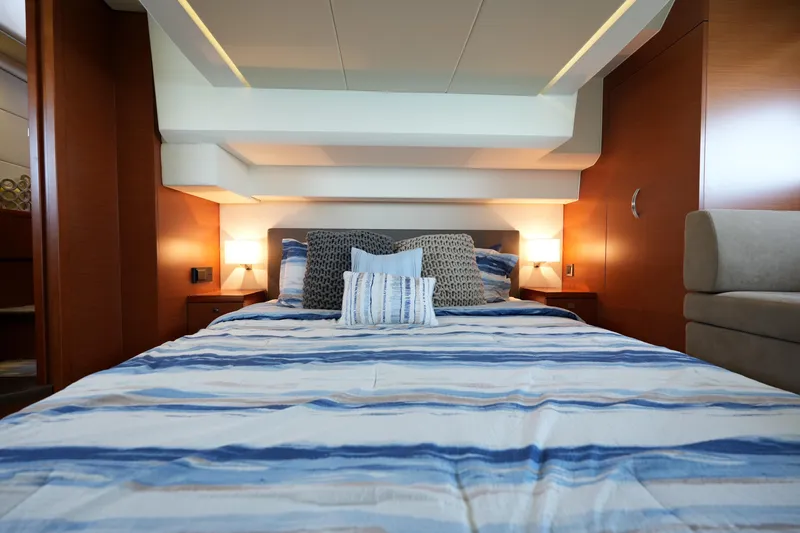 Slide: The Image of Luxurious bedroom interior of 2015 Prestige 500S yacht with striped bedding and ambient lighting. - 67