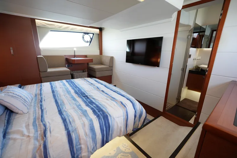 Slide: The Image of Luxurious 2015 Prestige 500S yacht cabin with bed, seating area, and modern amenities. - 68