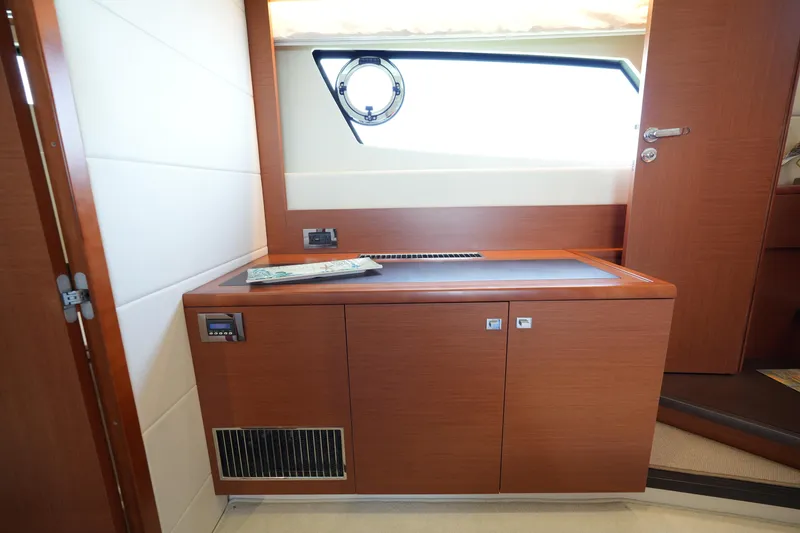Slide: The Image of Interior of 2015 Prestige 500S yacht with wooden cabinetry and porthole window. - 71