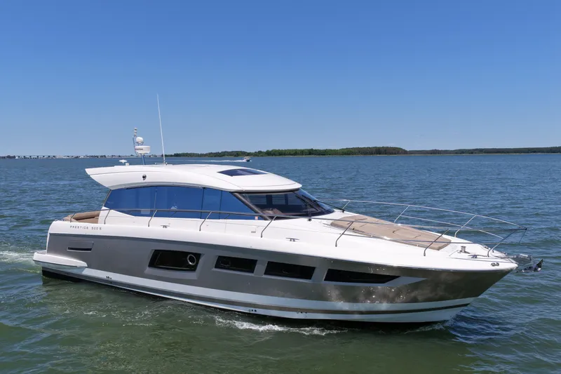 Slide: The Image of Luxury 2015 Prestige 500S yacht cruising on open water under clear blue sky. - 9