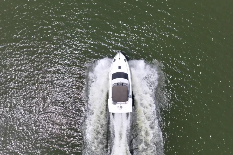 Slide: The Image of Overhead view of 1997 Sea Ray 370 Aft Cabin cruising on water. - 13