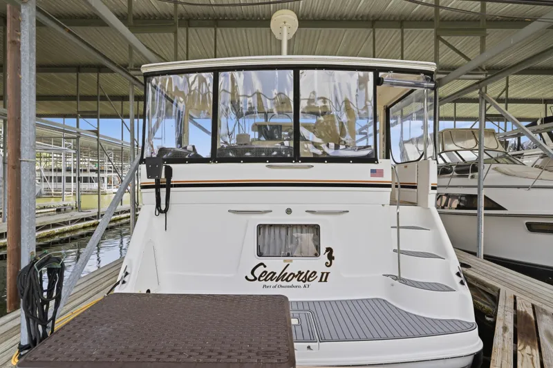 Slide: The Image of 1997 Sea Ray 370 Aft Cabin yacht docked in a marina, rear view. - 14