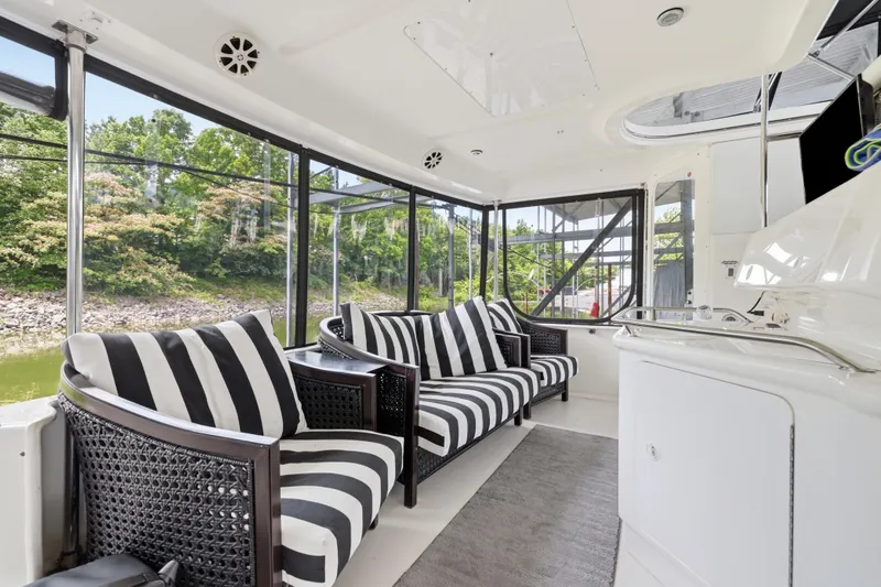 Slide: The Image of Interior of 1997 Sea Ray 370 Aft Cabin with striped seating and scenic views. - 23